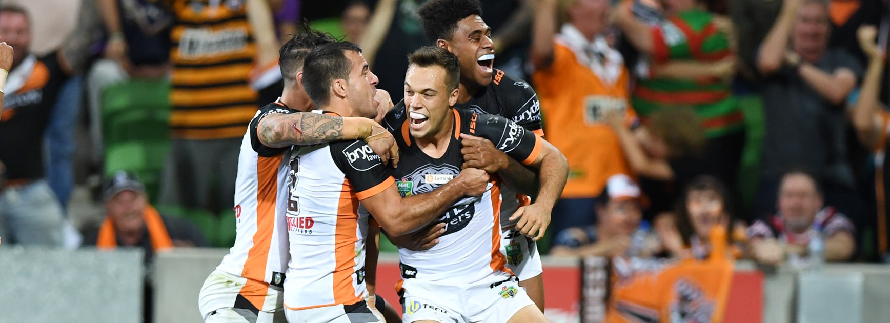 Tigers halfback Luke Brooks celebrates his try against the Storm.