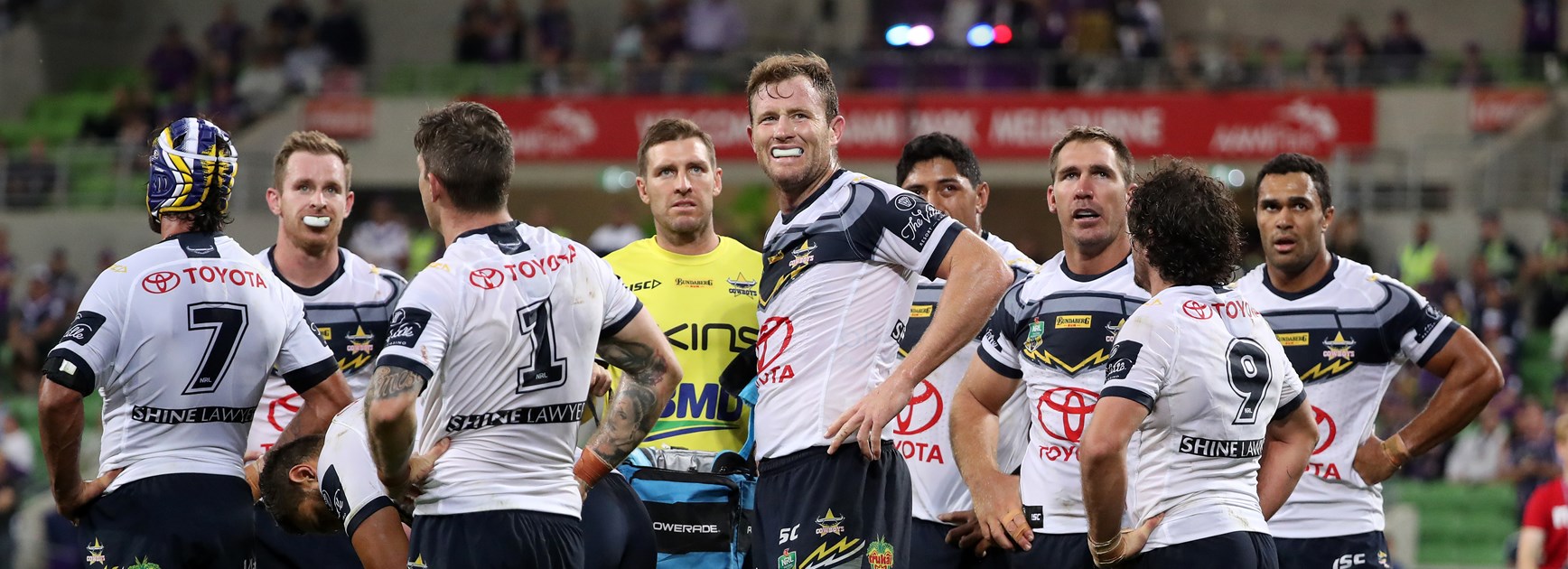 Cowboys players gather after letting in a try.