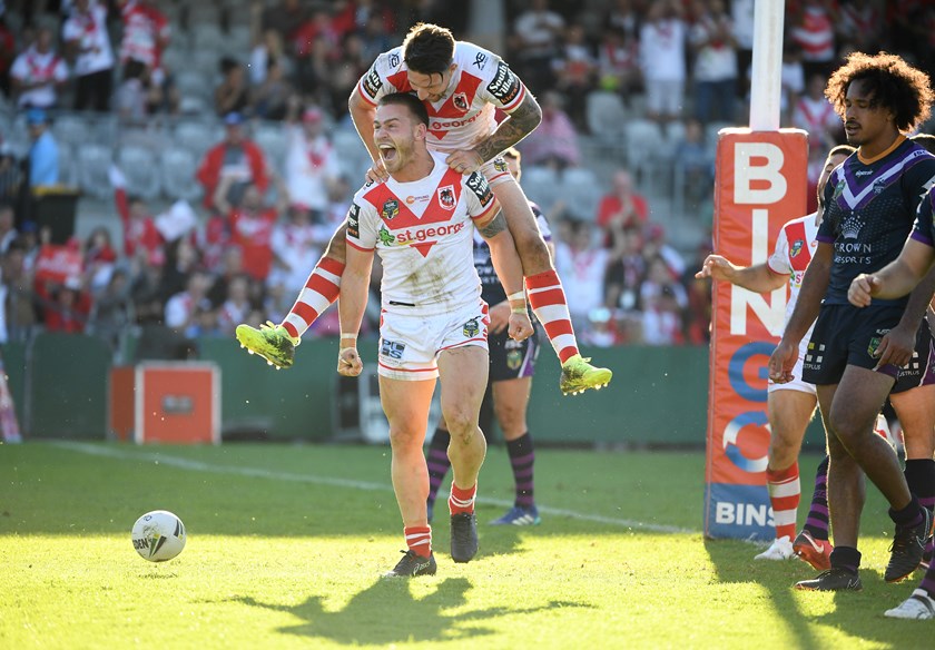 Dragons centre Euan Aitken gets a hug from Gareth Widdop.