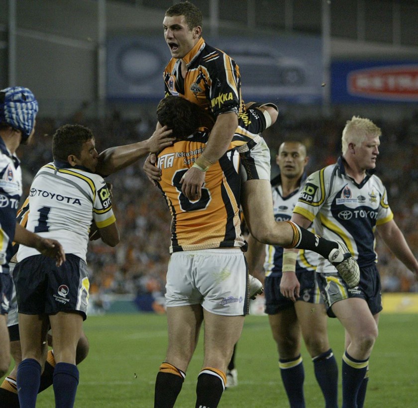 Robbie Farah celebrates the 2005 grand final win with Wests Tigers.
