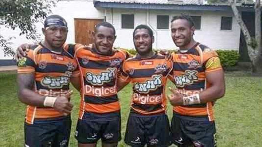 Justin Olam, right, with some of his Lae teammates.