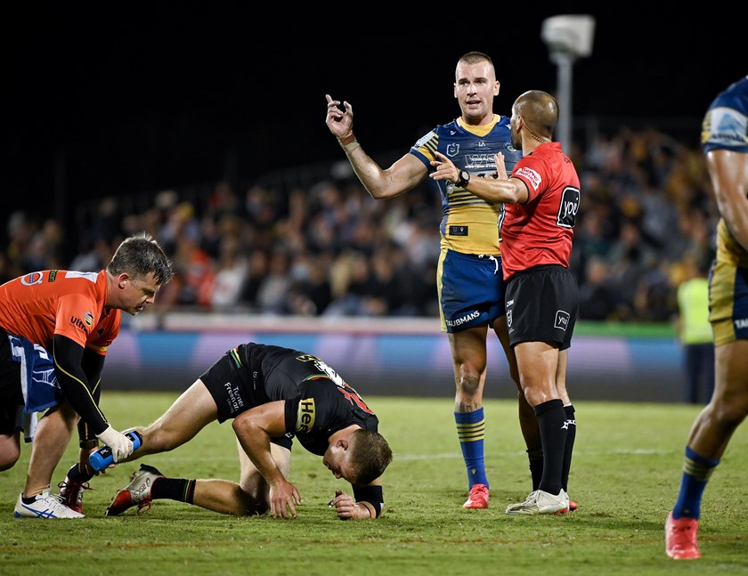 Mitch Kenny is treated by Panthers trainer Pete Green as Eels captain Clint Gutherson expresses his frustration.
