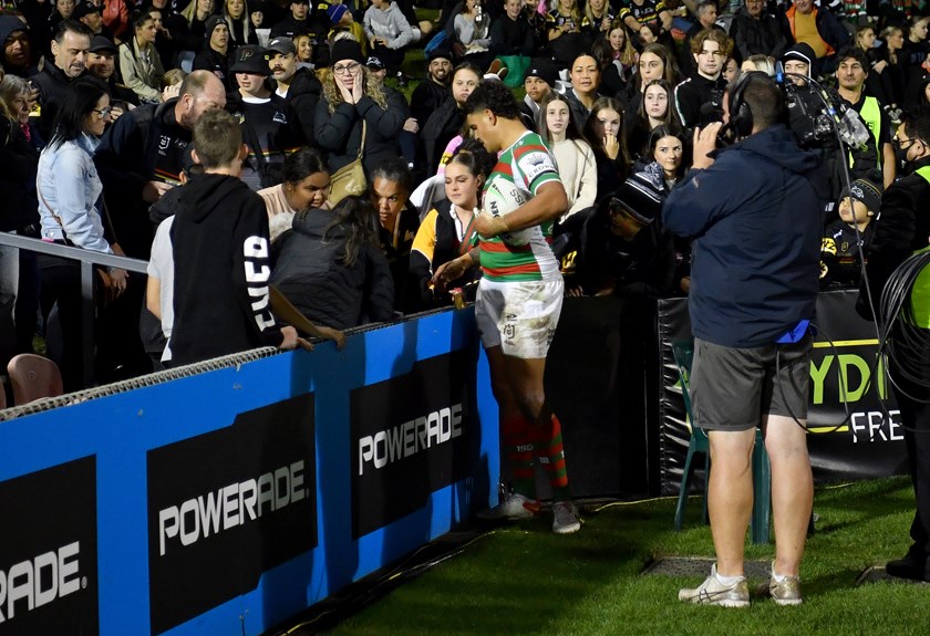 Latrell Mitchell checks on the condition of a woman hit by the ball