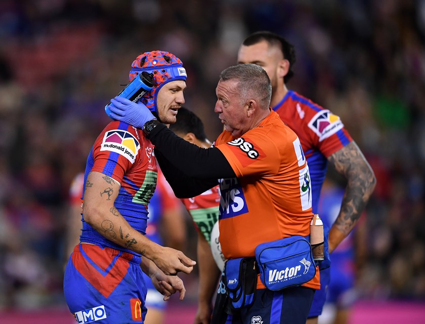 Knights fullback Kalyn Ponga undergoes a head injury assessment on field.