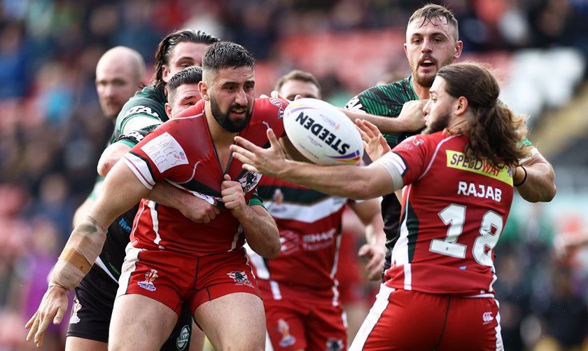 Rajab receives an offload from Kayne Kalache during Lebanon's win against Ireland 