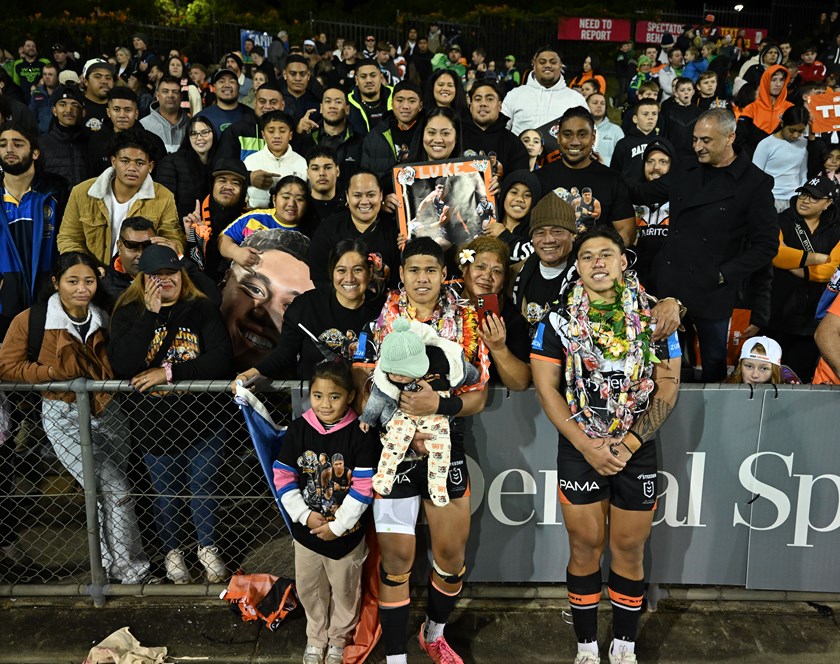 Kit and Luke Laulilii with family members after their first NRL appearance together for Wests Tigers.