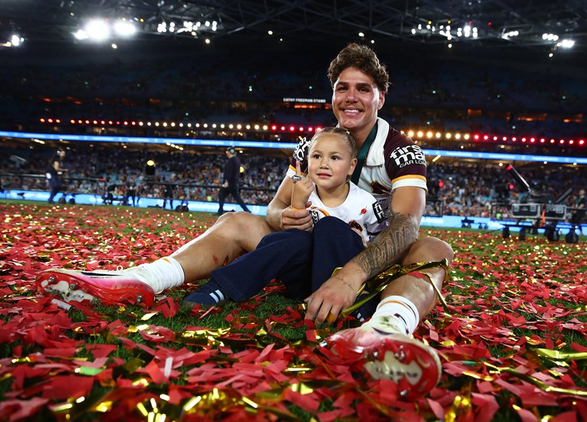 Reece Walsh and daughter Leila celebrates Brisbane's grand final win over the Storm. 